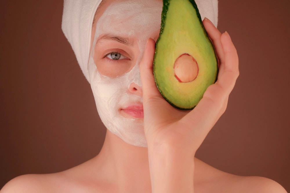 Model with Avocado for the best face mask recipe