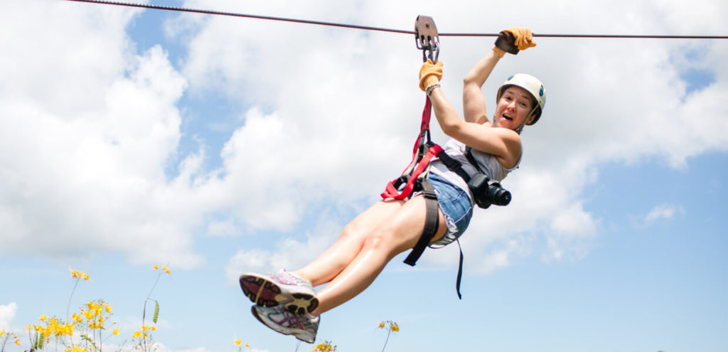 First-time visitor zip lining through the Costa Rica rainforest canopy on the Osa Peninsula