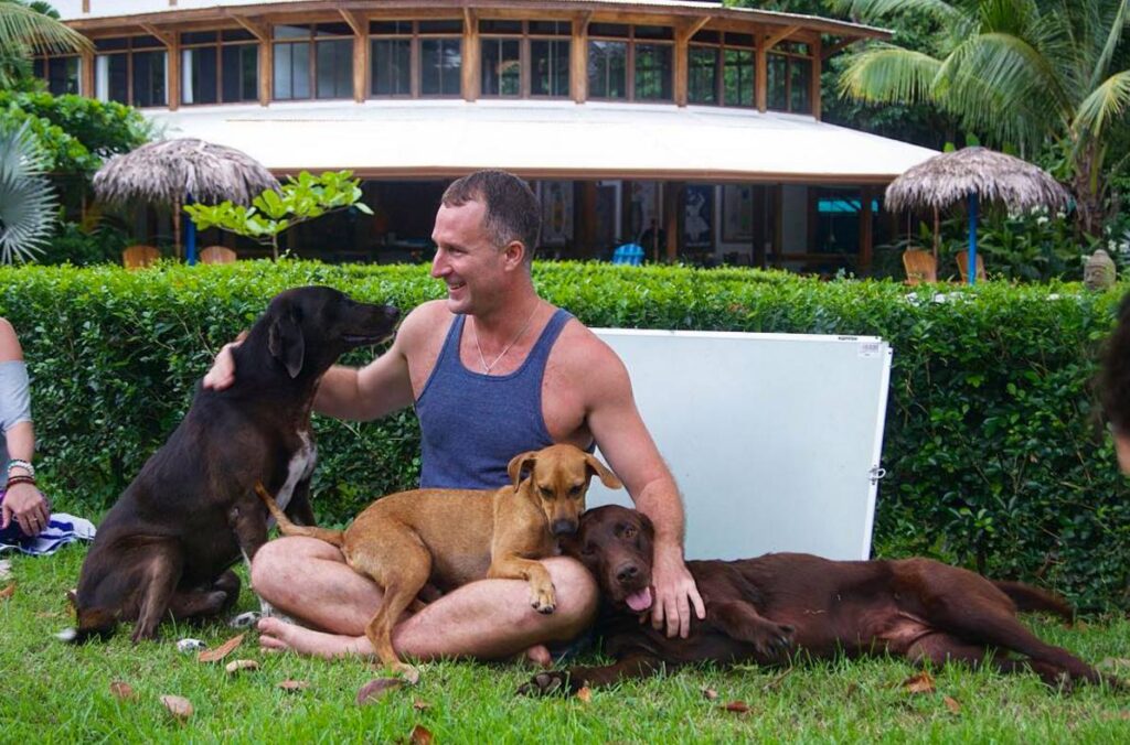 rescue dogs in costa rica yogi aaron with dogs blue osa yoga retreat center costa rica