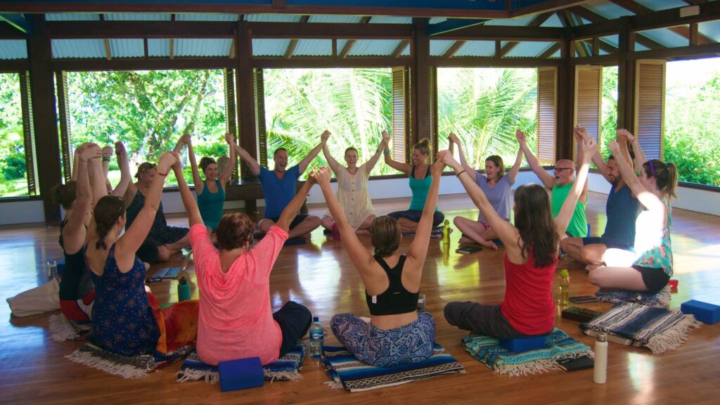 Yoga teacher training students practicing together in the Blue Osa shala — community is central to the best yoga teacher trainings in the world