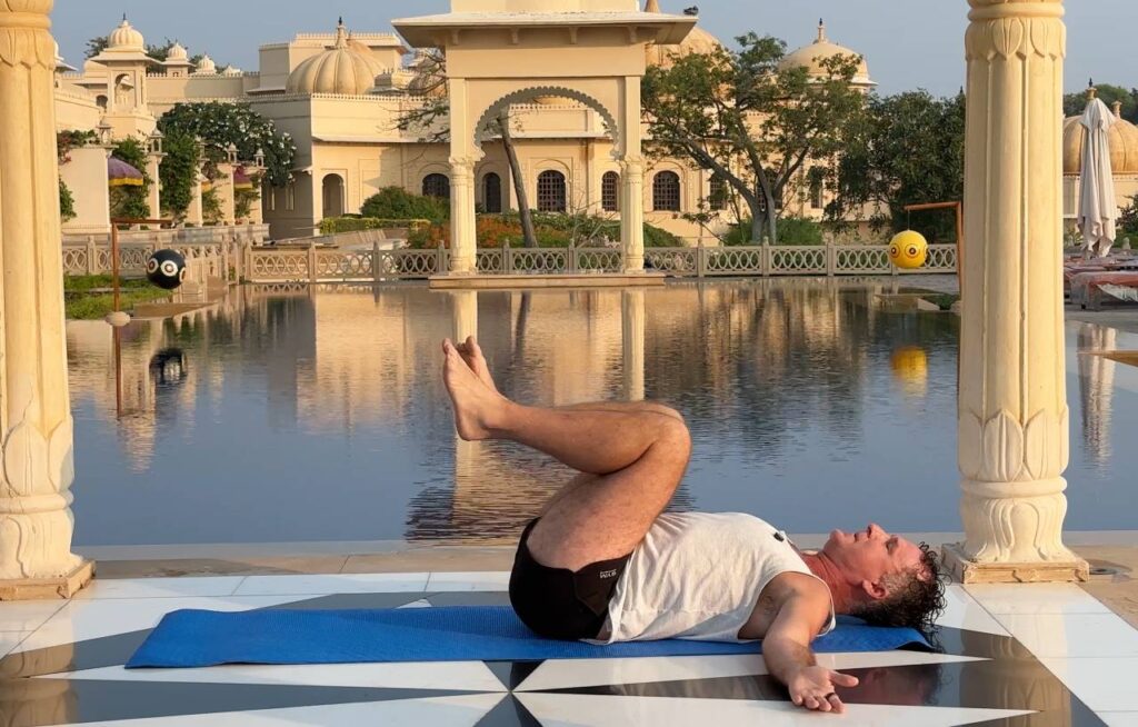 apanasana knees to chest pose demonstrated by yogi aaron is one of the best yoga poses for back pain