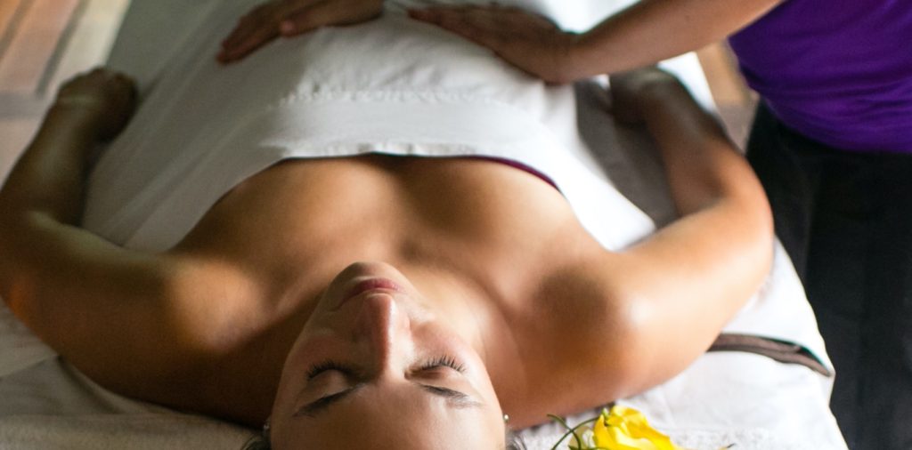 person laying on a massage table getting a massage.
