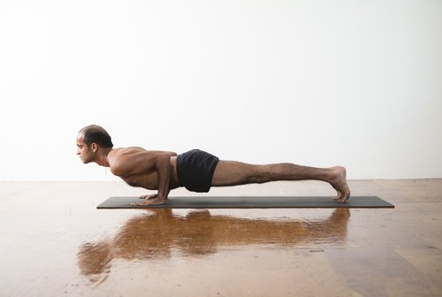 man doing chutranga dandasana