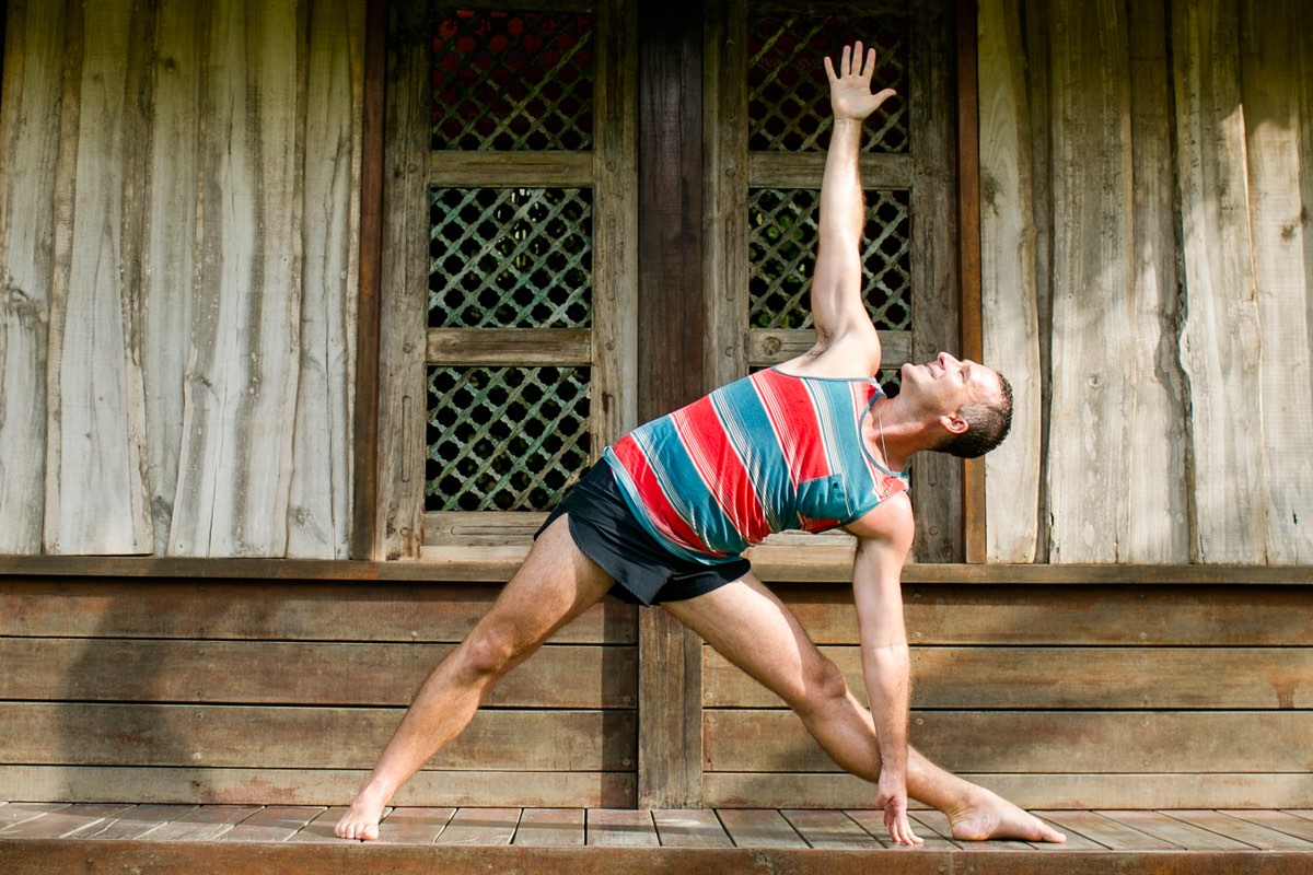 Yogi Aaron practicing triangle pose in Costa Rica.