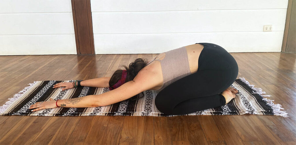 Woman in a child's pose position. 