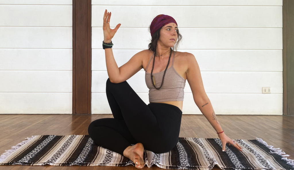 A yoga student practicing Seated Supine Twist in Blue Osa's yoga shala in Costa Rica. 