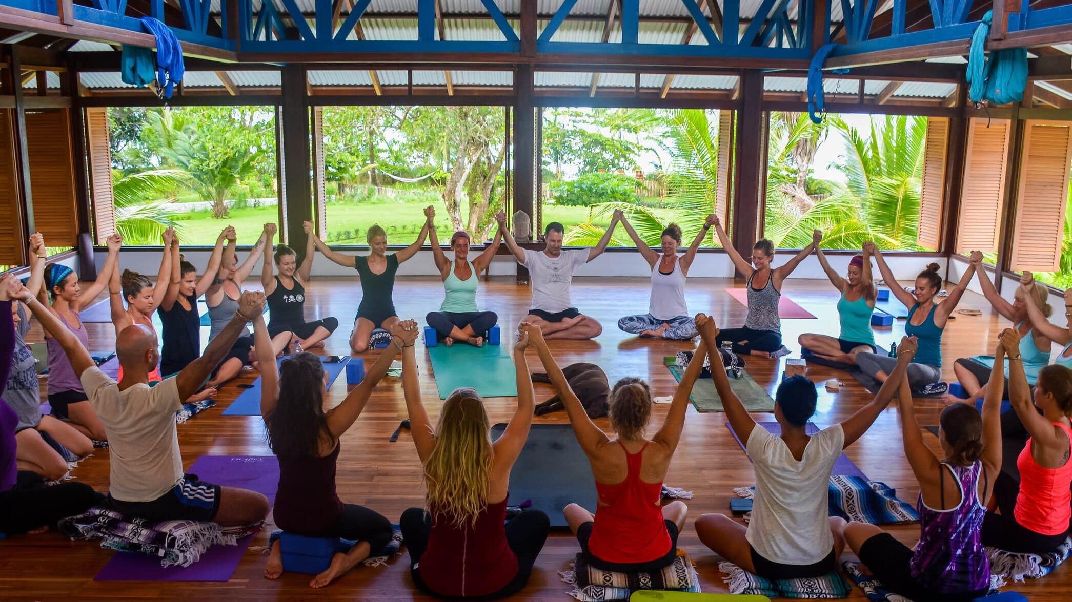 Welcome to the yoga teacher training at blue osa | yoga group in a big circle