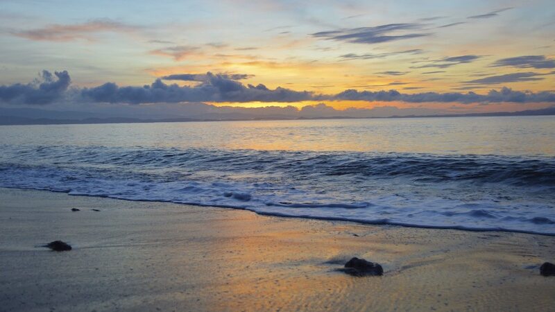 Sunrise with orange and light blue colors on the beach in Costa Rica.