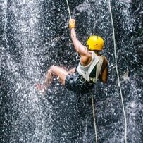 Man repelling down a waterfall in Costa Rica. 