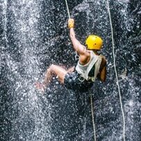 Man repelling down a waterfall in Costa Rica.