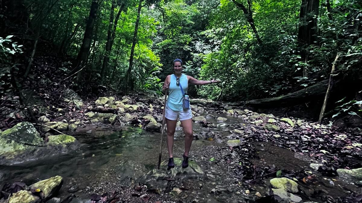 Carly standing in a creek on her Matapalo hike in Costa Rica. 