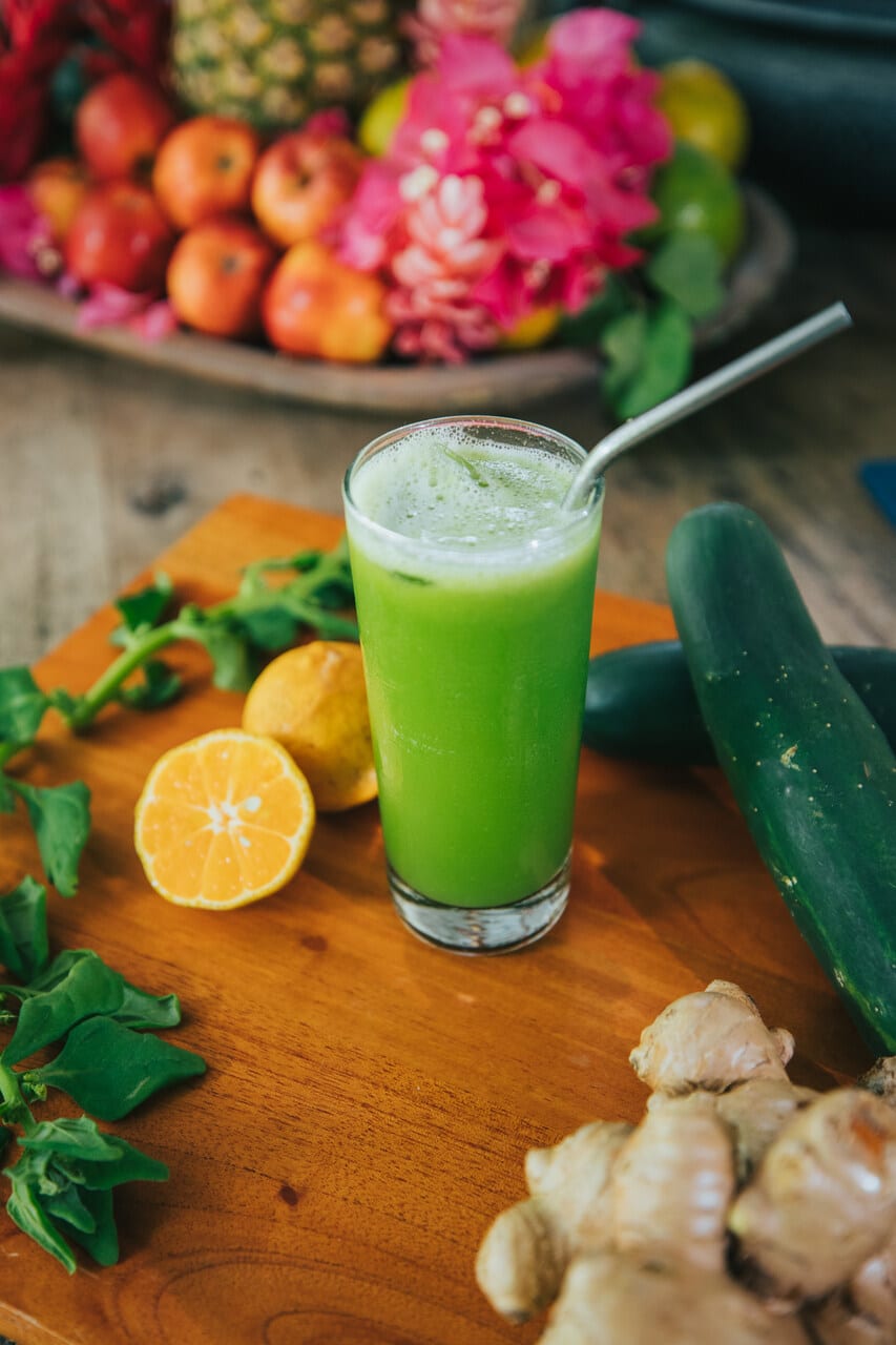 green juice, lemons, on a wooden board