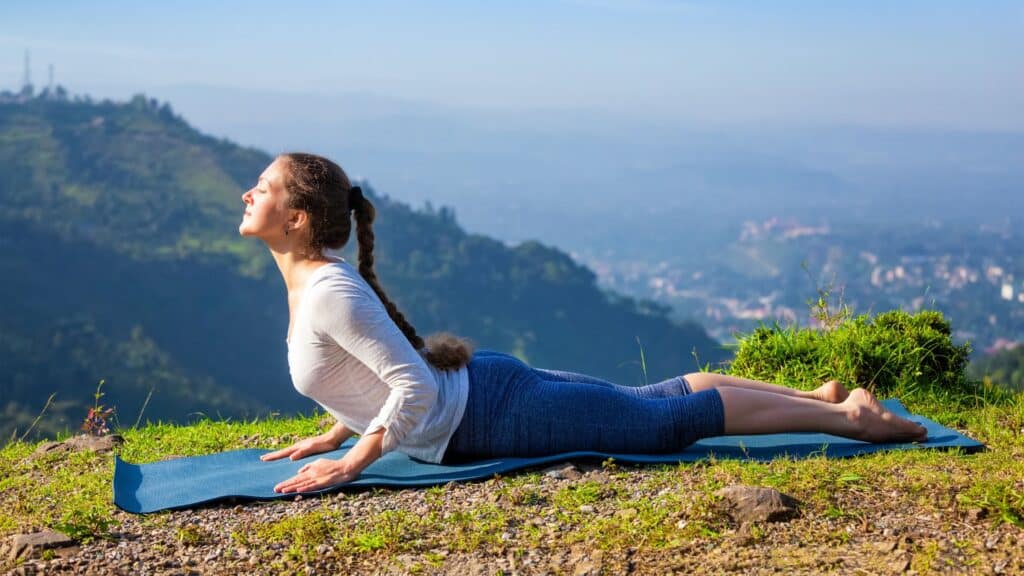 Woman doing Cobra Yoga Pose outside in nature