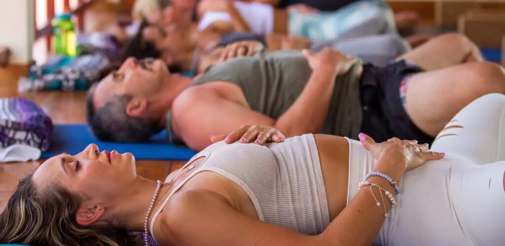 People laying in Savasana doing relaxation at Blue Osa Yoga Retreat & Spa in Costa Rica