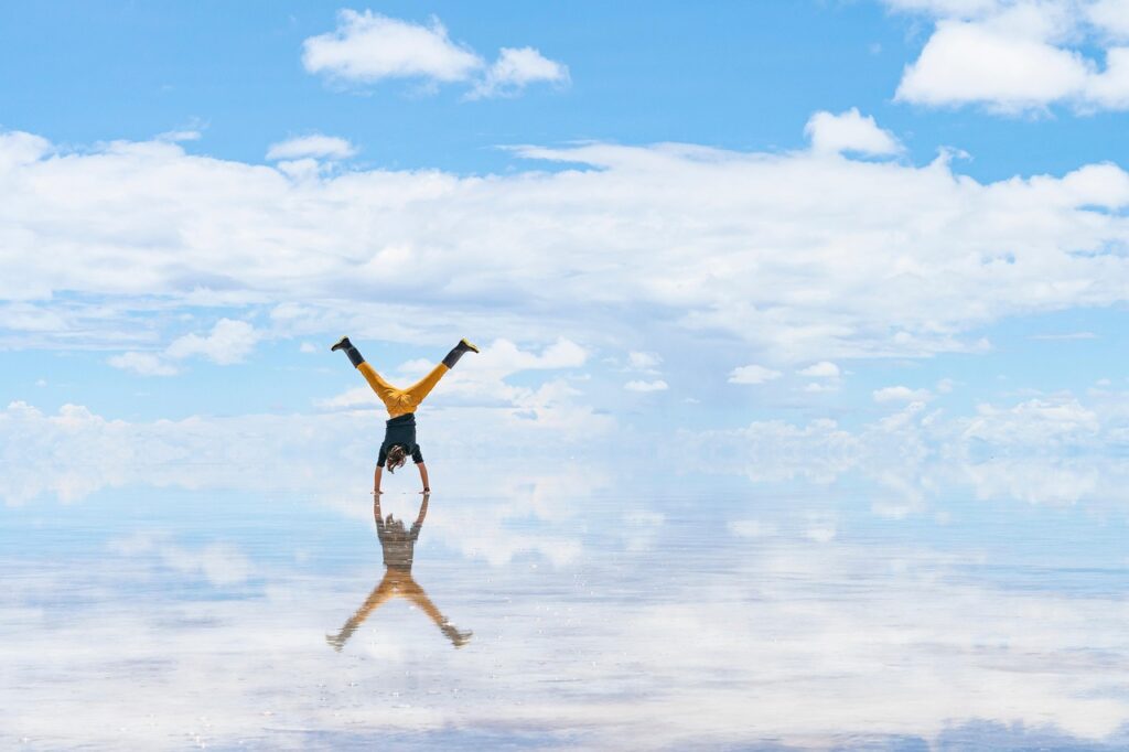 Person in yoga pose with reflection in water shadow authentic yoga transformation