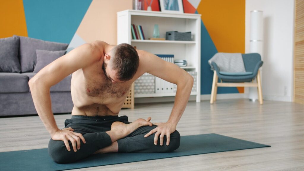 Man practicing yoga in a living room pranayama