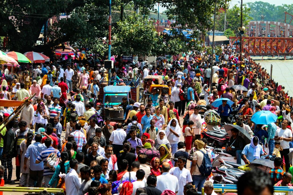 people sitting on chair during daytime chaotic india street travel to india journey to india