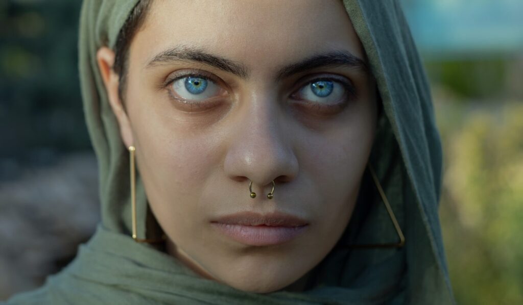 a person with a piercing gaze drishti warrior 3 pose
