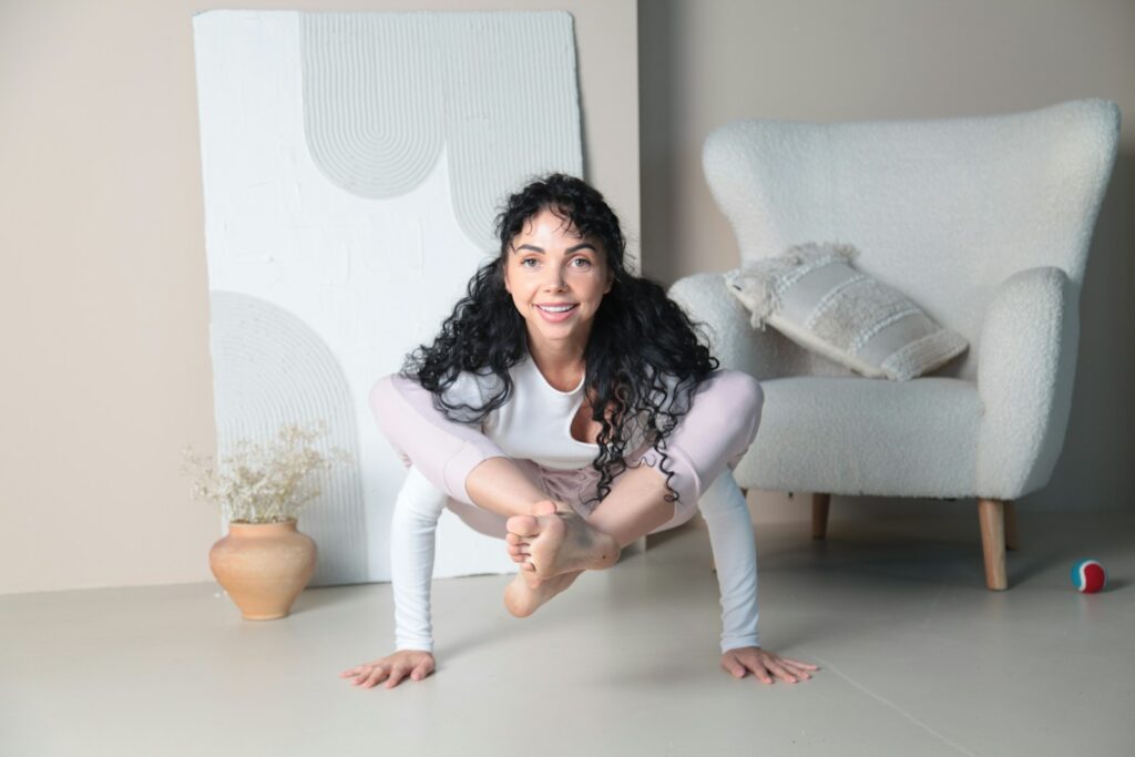 a woman is posing for a picture in front of a chair
Joyful yoga practice home fun playful sustainable Blue Osa approach