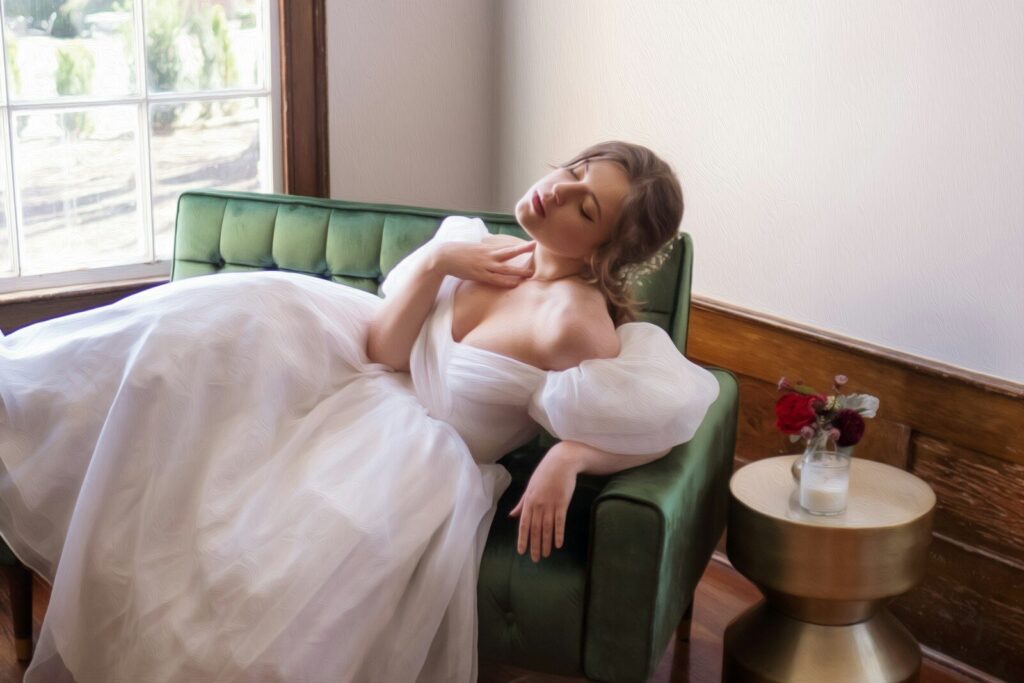 woman in white dress sitting on green sofa exhausted bride how to save money on your wedding affordable destination wedding