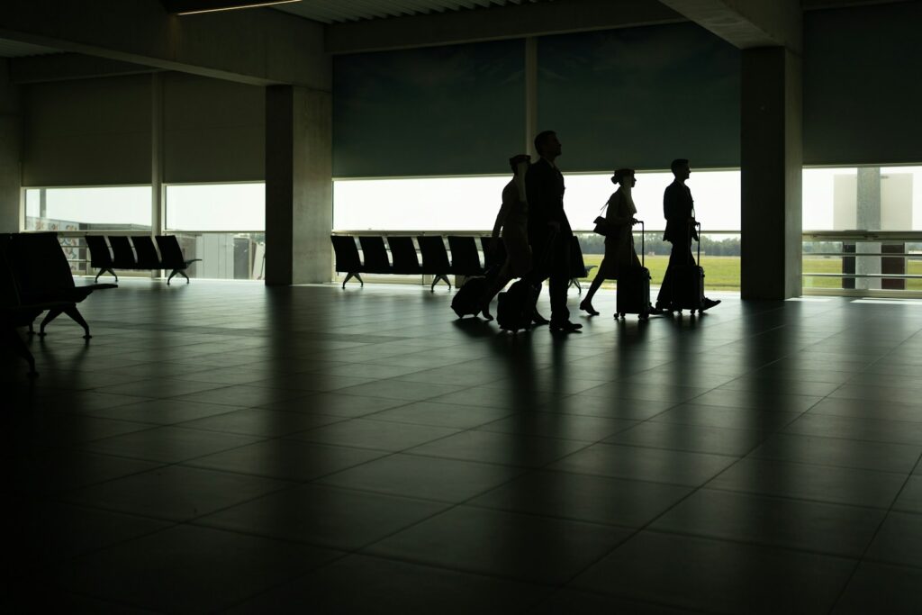 a group of people walking through an airport yoga poses for travel