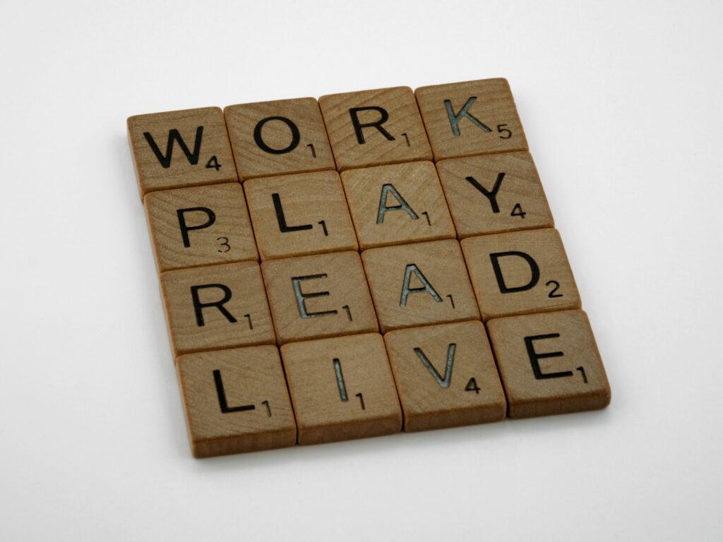 a scrabble tile with words that read work play read live get it all done on a working vacation