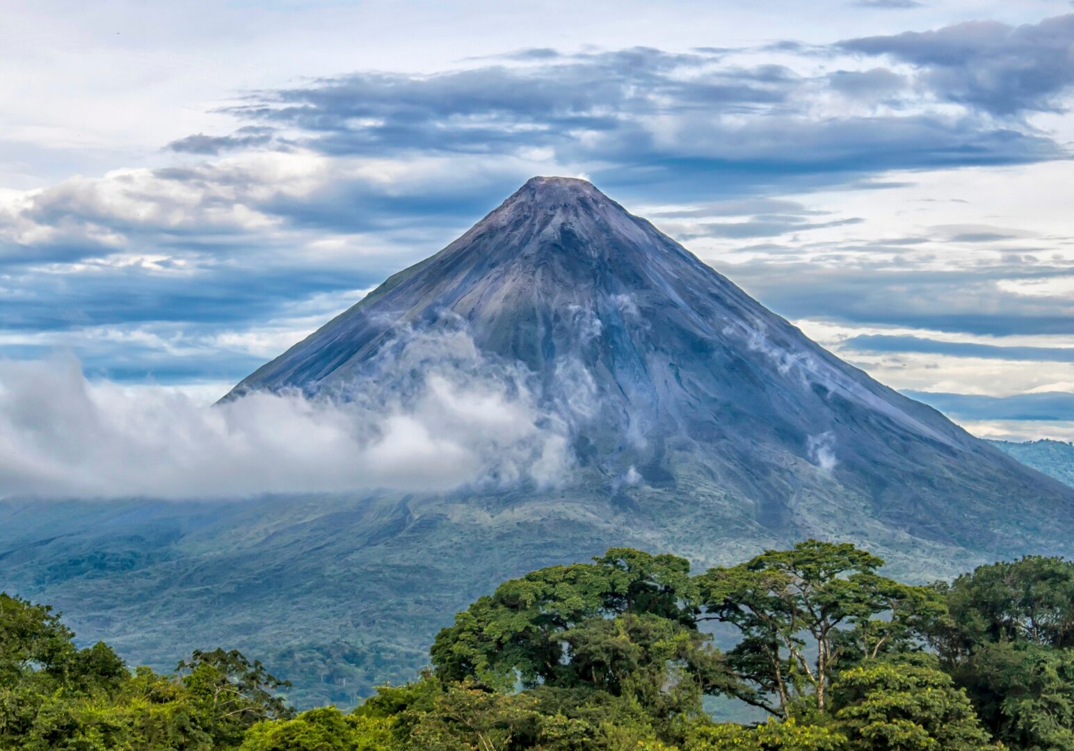 Volcano Arenal in Costa Rica with clowds around it