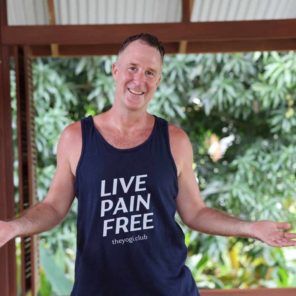 Yogi Aaron wearing a t-shirt "live pain free" in the yoga studio at Blue osa Yoga Retreat and spa